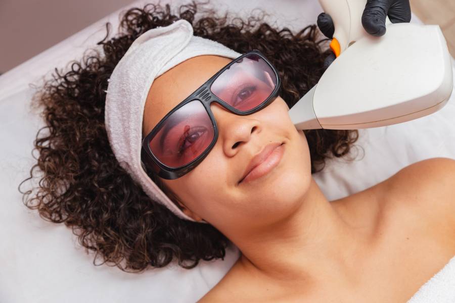 Brazilian black woman performing laser hair removal on upper lip