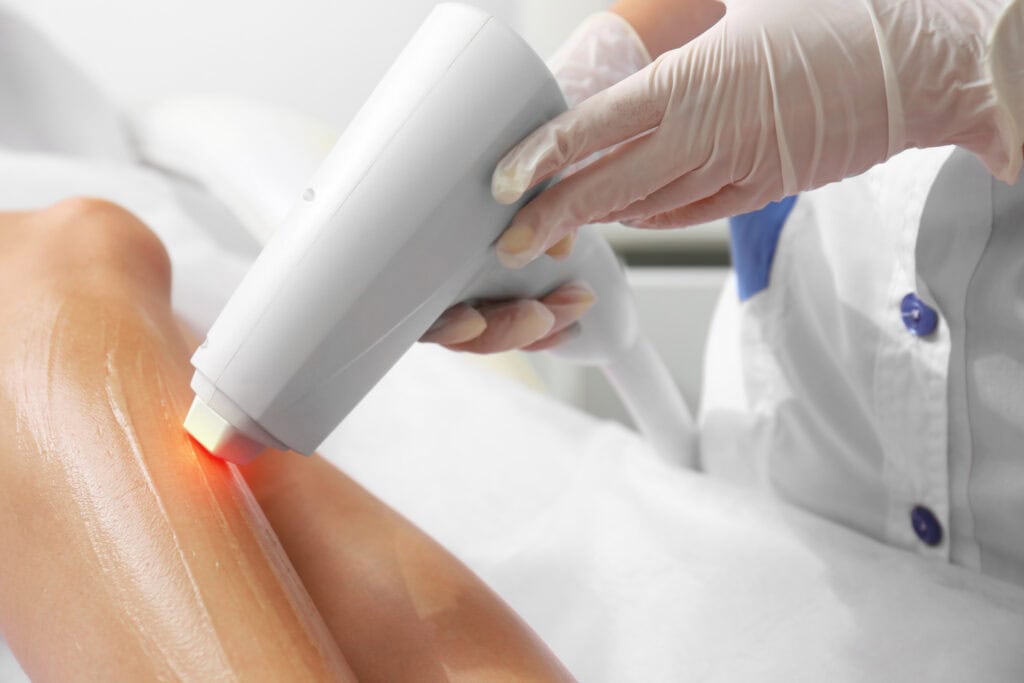 Woman getting laser treatment in a beauty salon, close up